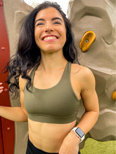 Load image into Gallery viewer, Army green sports bra with medium support, removable pads and a criss cross back
