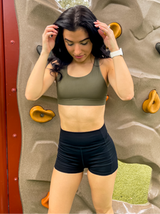 Army green sports bra with medium support, removable pads and a criss cross back