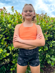 The Youth Peachy Shorts are high-waisted in color black camo with a 75% nylon, 25% spandex blend. Extra stretchy fabric provides extra comfort while still providing a more fitted appearance.