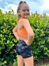 Load image into Gallery viewer, The Youth Peachy Shorts are high-waisted in color black camo with a 75% nylon, 25% spandex blend. Extra stretchy fabric provides extra comfort while still providing a more fitted appearance.
