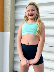 The Youth Peachy Shorts are high-waisted in color black with a 75% nylon, 25% spandex blend. Extra stretchy fabric provides extra comfort while still providing a more fitted appearance.