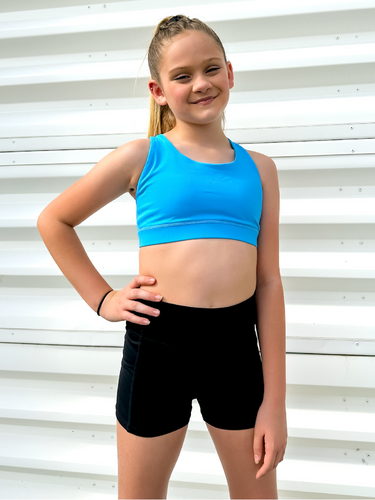 Young girl modeling sky blue strappy sports bra.