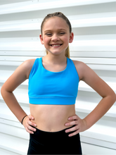 Load image into Gallery viewer, Young girl modeling sky blue strappy sports bra.
