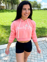 Load image into Gallery viewer, Young lady modeling Peachy Pia Peachy Shorts. Peachy Shorts are high-waisted in color black with a 75% nylon, 25% spandex blend. Extra stretchy fabric provides extra comfort while still providing a more fitted appearance.
